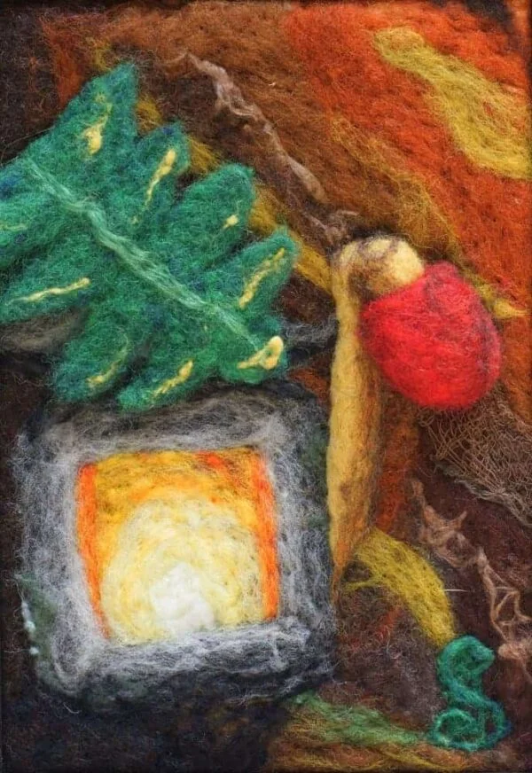 Red and Gold unopened mushroom is broken at the stem. A large green frond is covering the top of an asian style lantern. A flame inside the