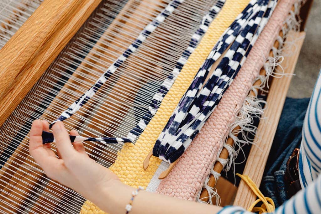 A Person Weaving Fabric by Hand
